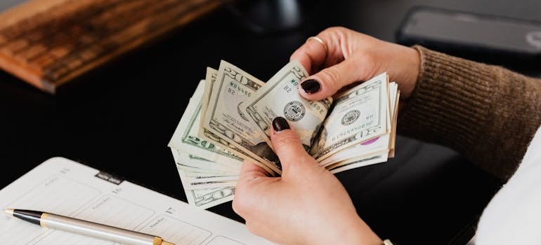 A person counting money after learning how to move a car
