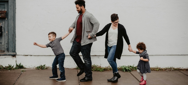 A family of four holding hands.