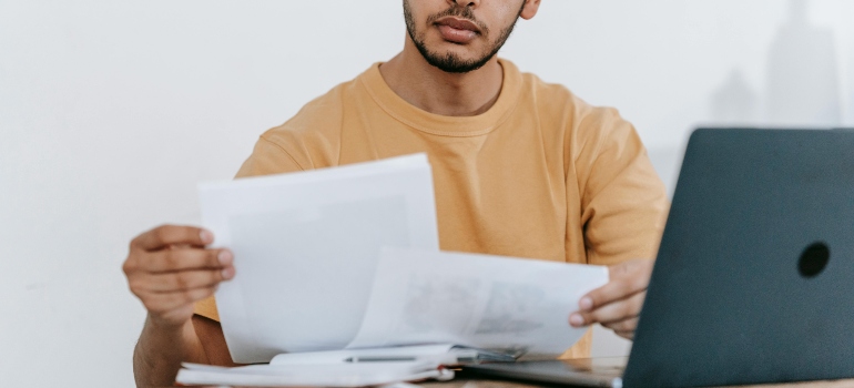 Broker verifying mover insurance meets safety and compliance standards.