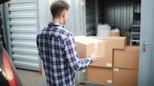 Man packing boxes in garage for a last-minute move.