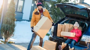 Family moving into a new house during winter.